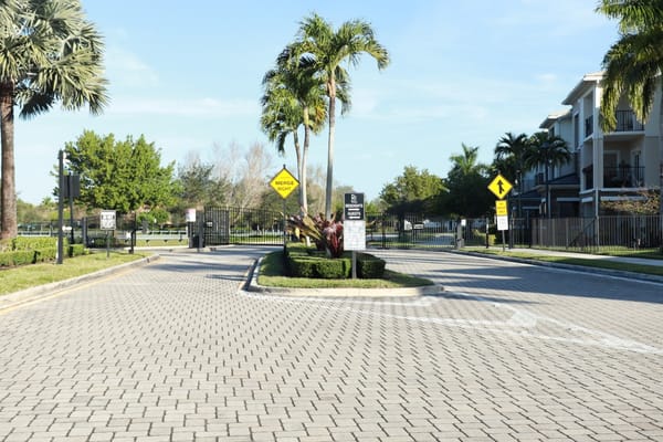 Entrance to a senior living facility with tropical landscaping