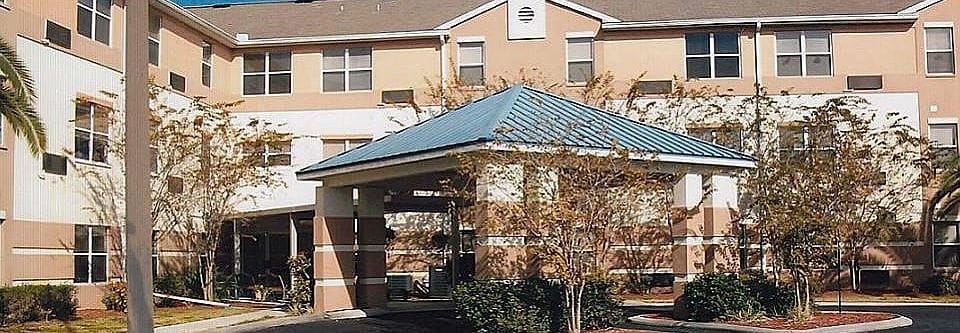 Front view of Sandpiper Run with a blue roof and landscaping