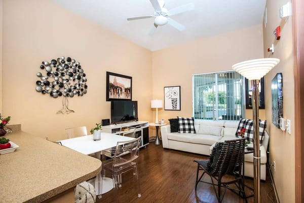 Stylish living room with a modern design featuring a white couch and dining area.