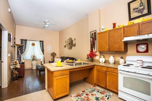 Cozy kitchen area with wooden cabinets and dining space.