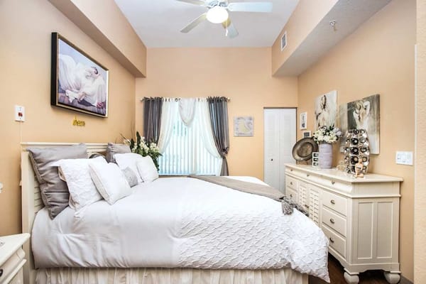 A beautifully decorated bedroom with a large bed and elegant furnishings.