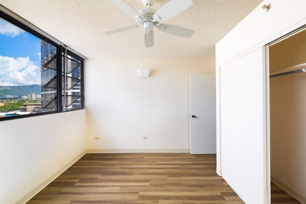 Bright private room with wooden flooring and large window