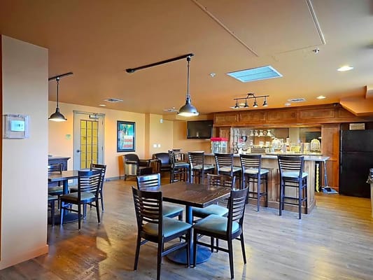 Interior view of a dining area with tables and a bar