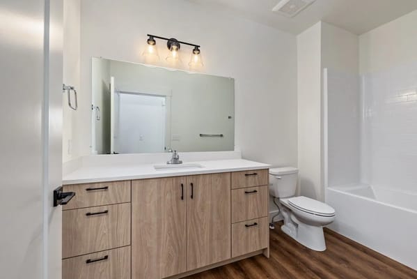Modern bathroom with wooden vanity and mirror