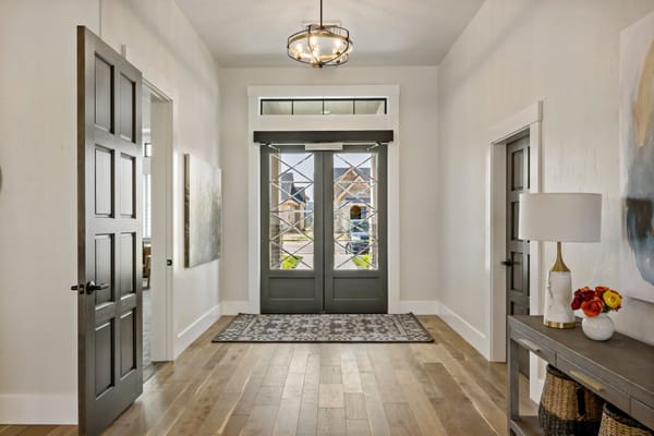 Bright entryway with double doors and decorative furnishings