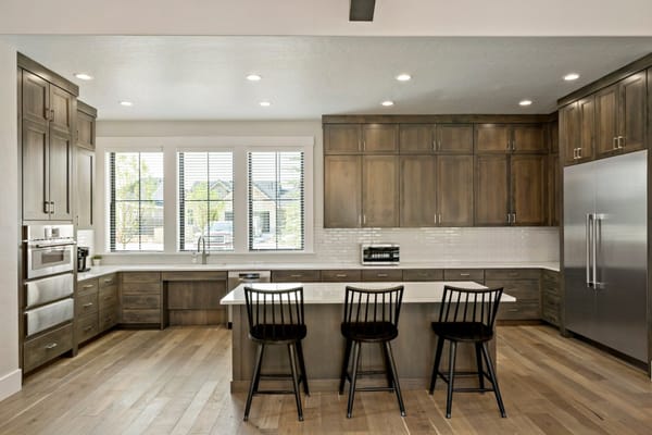 Spacious kitchen with modern cabinetry and bar stools