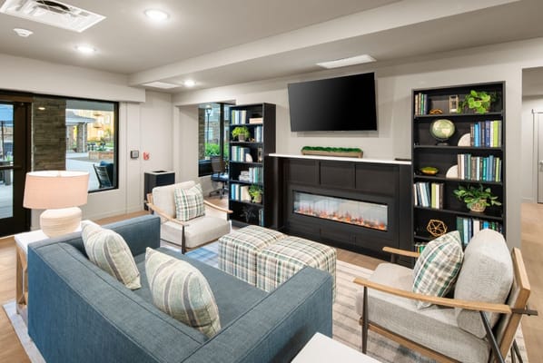 Bright common area with comfortable seating and a fireplace