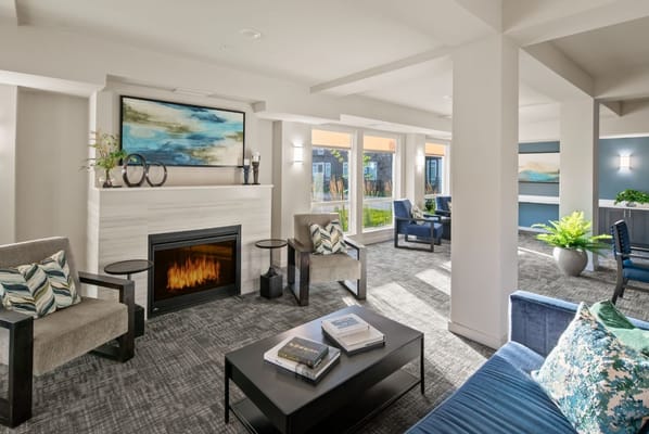 Bright common area with seating and fireplace