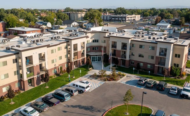 Aerial view of Mercy Creek Apartments showing the entrance and parking area.
