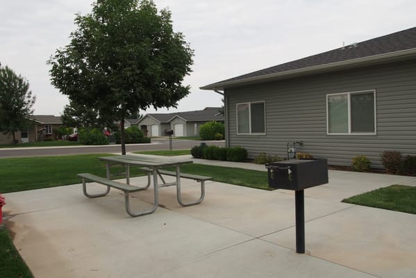 Outdoor picnic area with tables and greenery