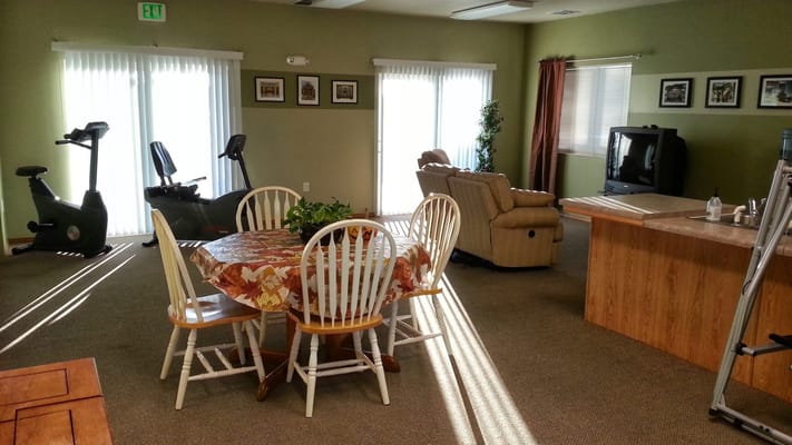 Bright common area with exercise equipment and seating