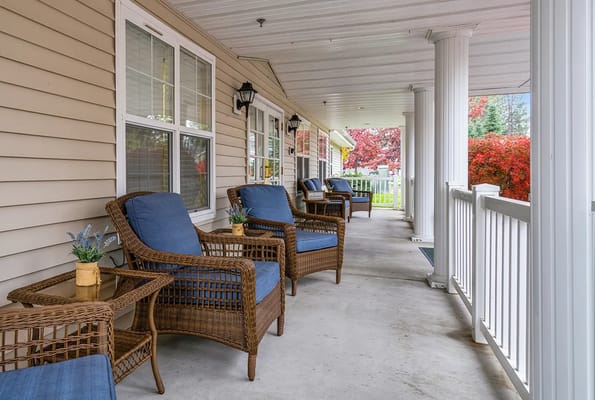 Outdoor seating area with chairs and potted plants