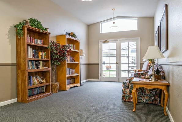 Comfortable seating area with bookshelves and natural light