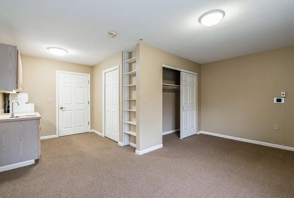 Empty resident room with beige walls and carpet