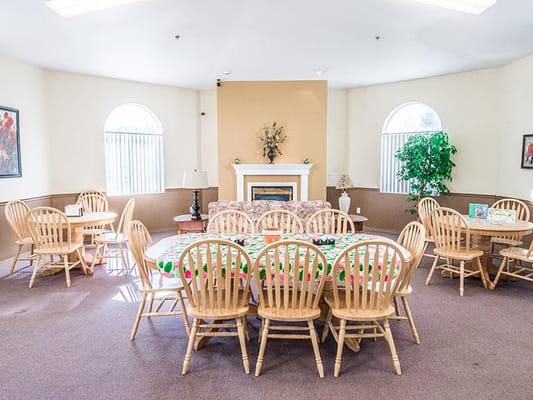 Bright common area with wooden tables and chairs