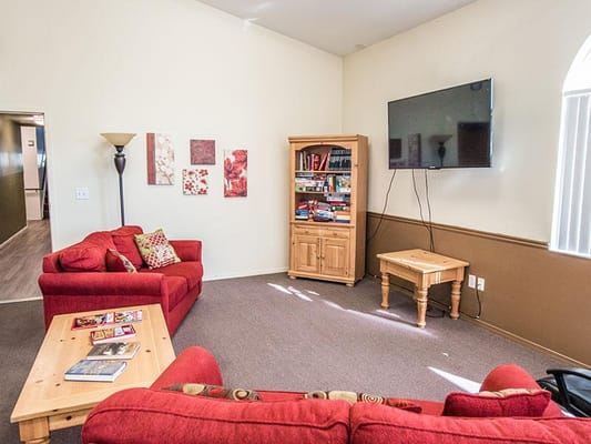 Bright common area with sofas and a TV