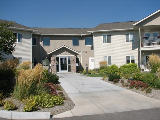 Main entrance of Rosslare Senior Apartments with landscaped garden