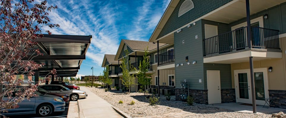Exterior view of Bandon River Apartments with parked cars