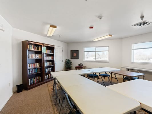 Bright, spacious activity room with bookshelves