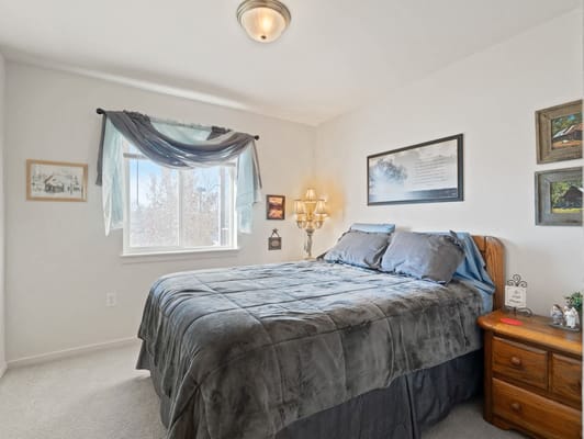 Cozy bedroom with a bed, window, and soft decor