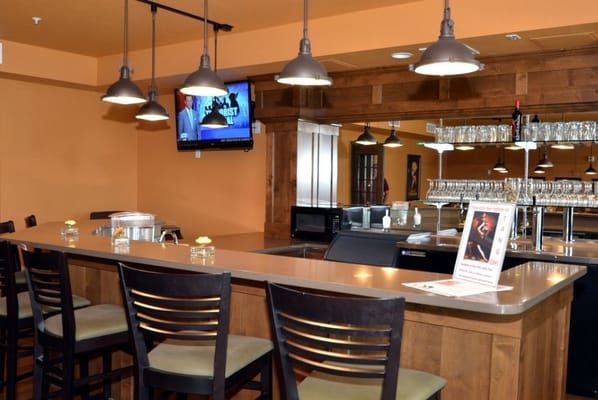A cozy bar area with wooden finishes and seating