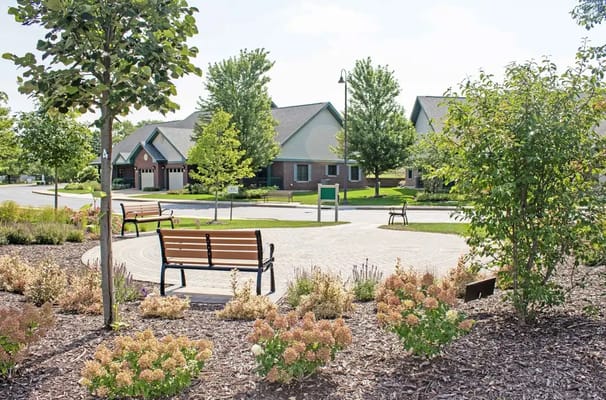 Outdoor seating area with benches in a landscaped garden