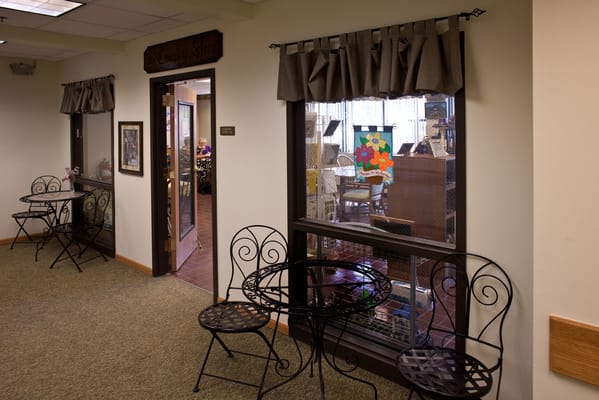 Interior hallway with seating and open door.
