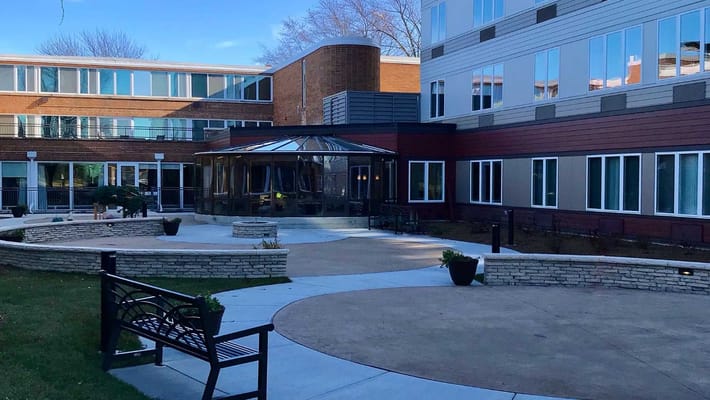 Spacious courtyard with benches and a gazebo at The Martin Avenue Apartments