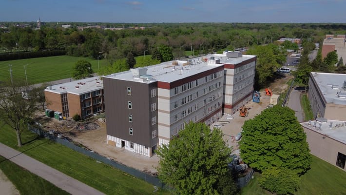 Aerial view of The Martin Avenue Apartments surrounded by greenery.