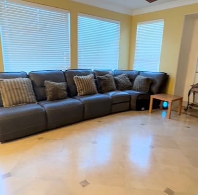 Spacious living room with a sectional sofa and natural light