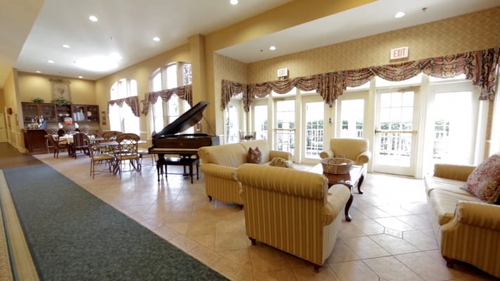 Bright interior lounge with comfortable seating and a piano