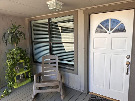 Entrance area with a chair, plant, and door