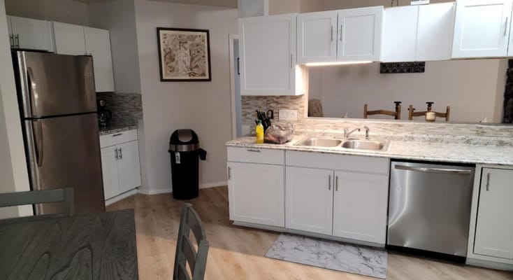 Modern kitchen with stainless steel appliances and granite countertops
