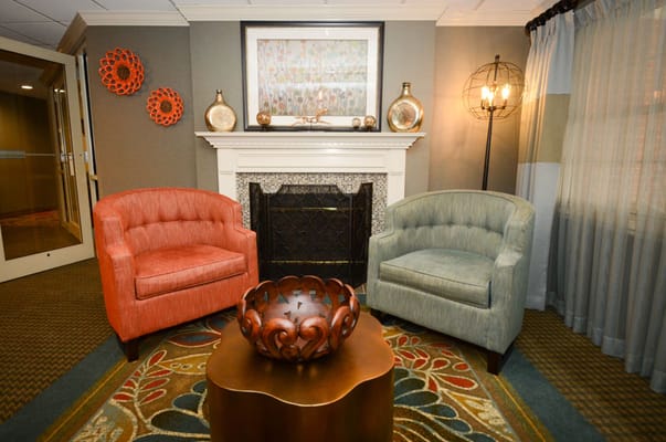 Cozy seating area with fireplace and artwork