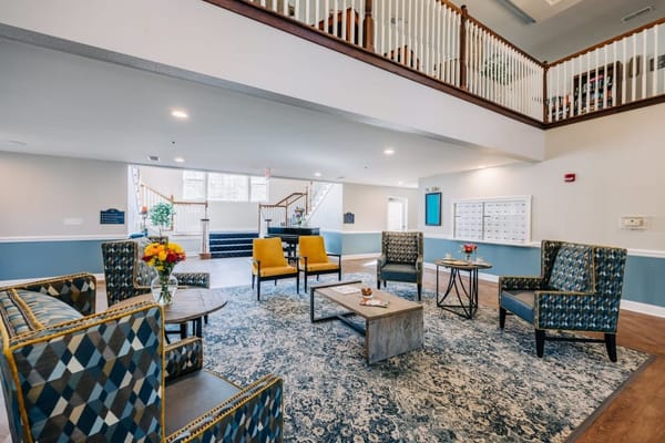Comfortable seating area with colorful chairs and a coffee table.
