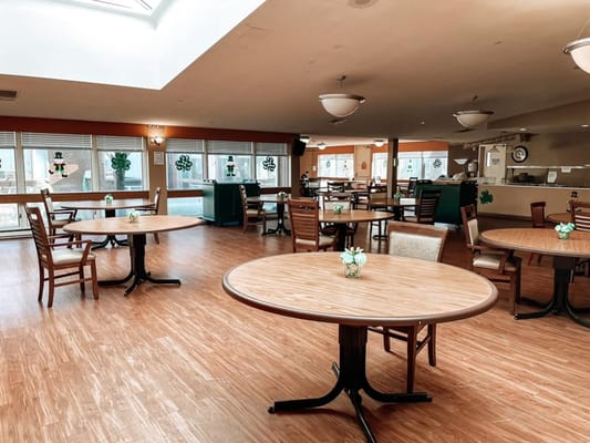 Bright dining area with tables and chairs set for activities
