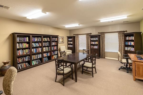 Cozy library area with bookshelves and a table for reading