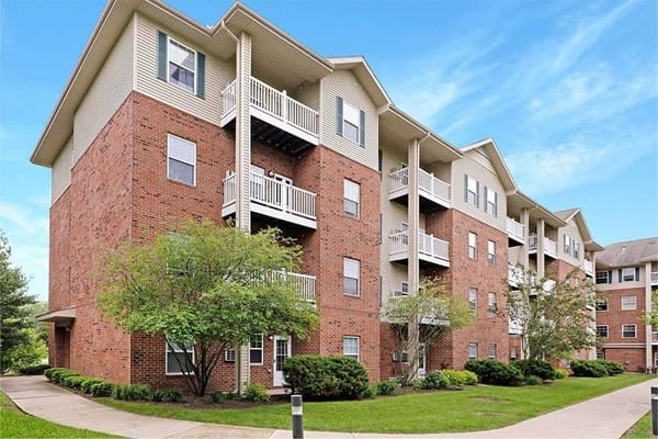 Exterior of The Reserve at Lakeview Apartments, showing balconies and landscaping.