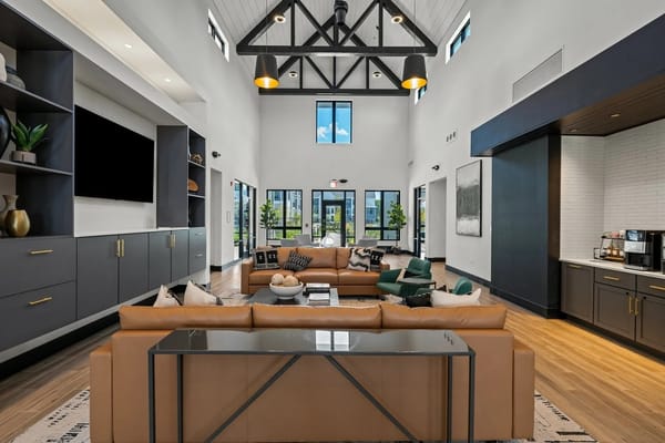 Modern living room featuring a large sectional sofa and natural light.