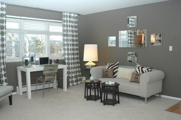 Living room featuring a sofa, side tables, and a desk with a computer.