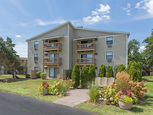 Exterior view of Barrington Lakes Apartments surrounded by greenery.