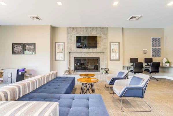 Sunny common area with seating and a fireplace