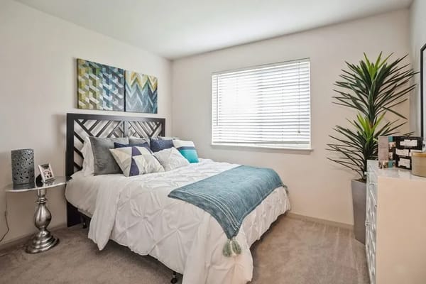 Cozy bedroom setup with artwork and plants