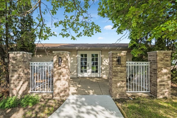 Exterior view of entrance with gates and landscaping
