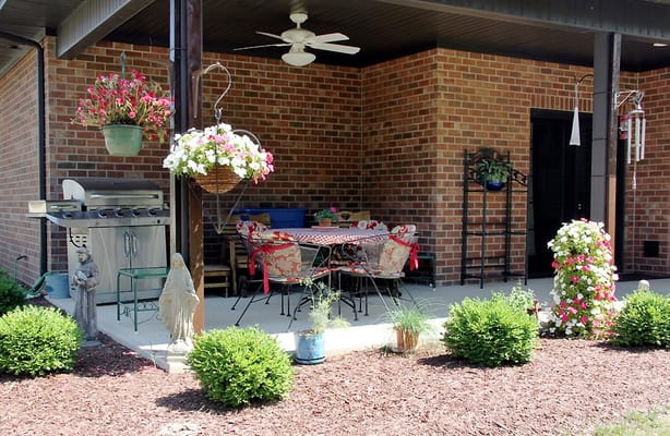 Outdoor patio area with dining table and flowers