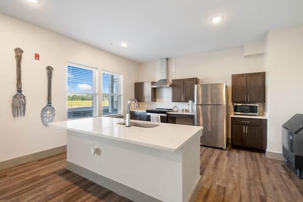 Modern kitchen area with appliances and countertops