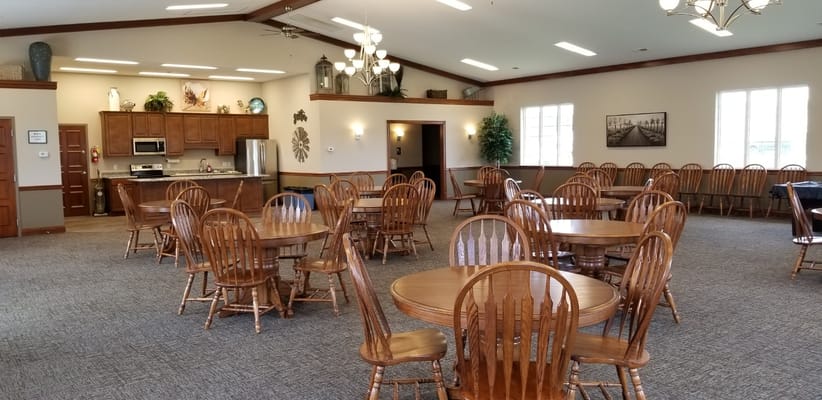 Spacious common area with wooden tables and chairs