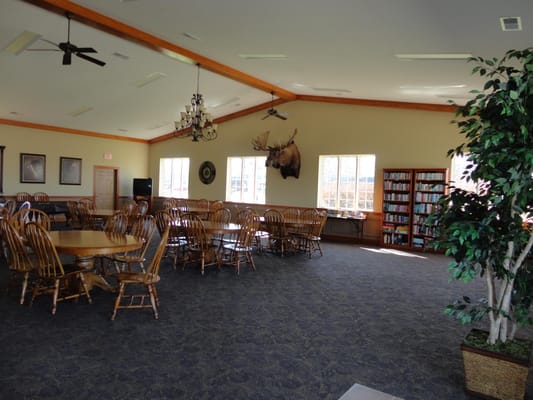 Spacious common area with tables and bookshelves
