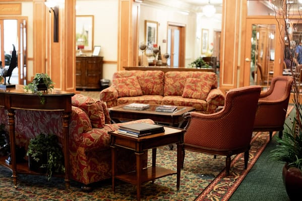 Cozy seating area with floral upholstered sofas and a wooden coffee table.