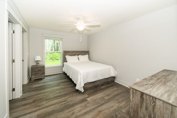 Brightly lit private room with a bed and furniture